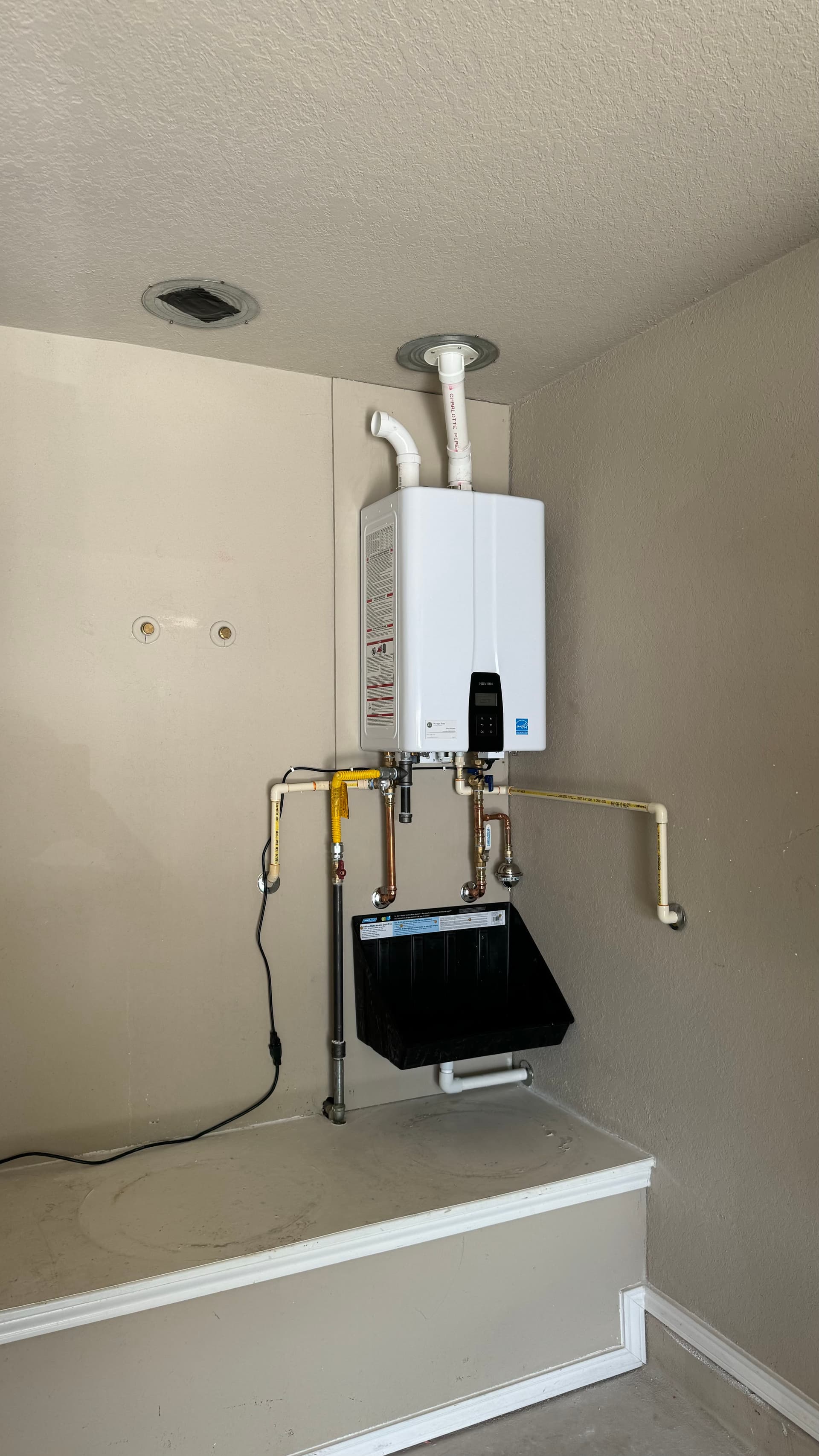 Two Old Tank Heaters Out, One Tankless System In image